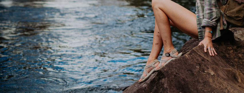 Woman on rocks wearing walking sandals