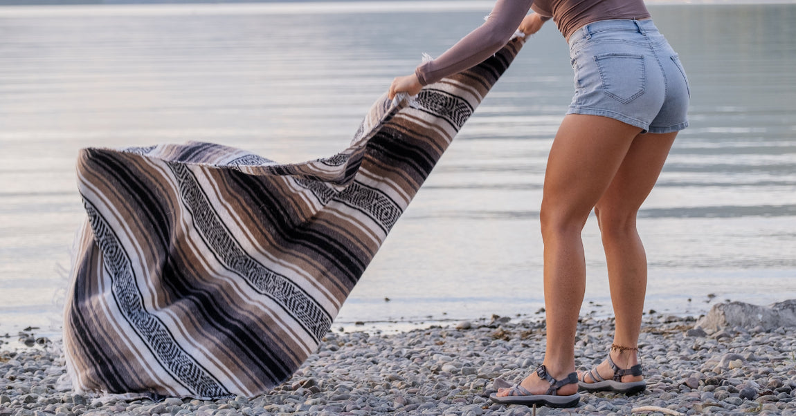 woman in water sandals next to a lake